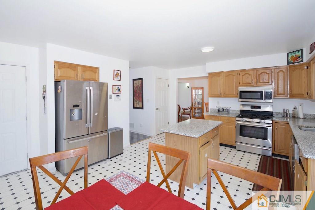 98 New Brooklyn Road Edison, NJ 08817 - Photo 7 of 21 a kitchen with stainless steel appliances granite countertop a refrigerator and a stove top oven