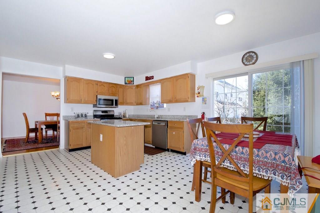 98 New Brooklyn Road Edison, NJ 08817 - Photo 8 of 21 a kitchen with stainless steel appliances kitchen island granite countertop a refrigerator and a stove