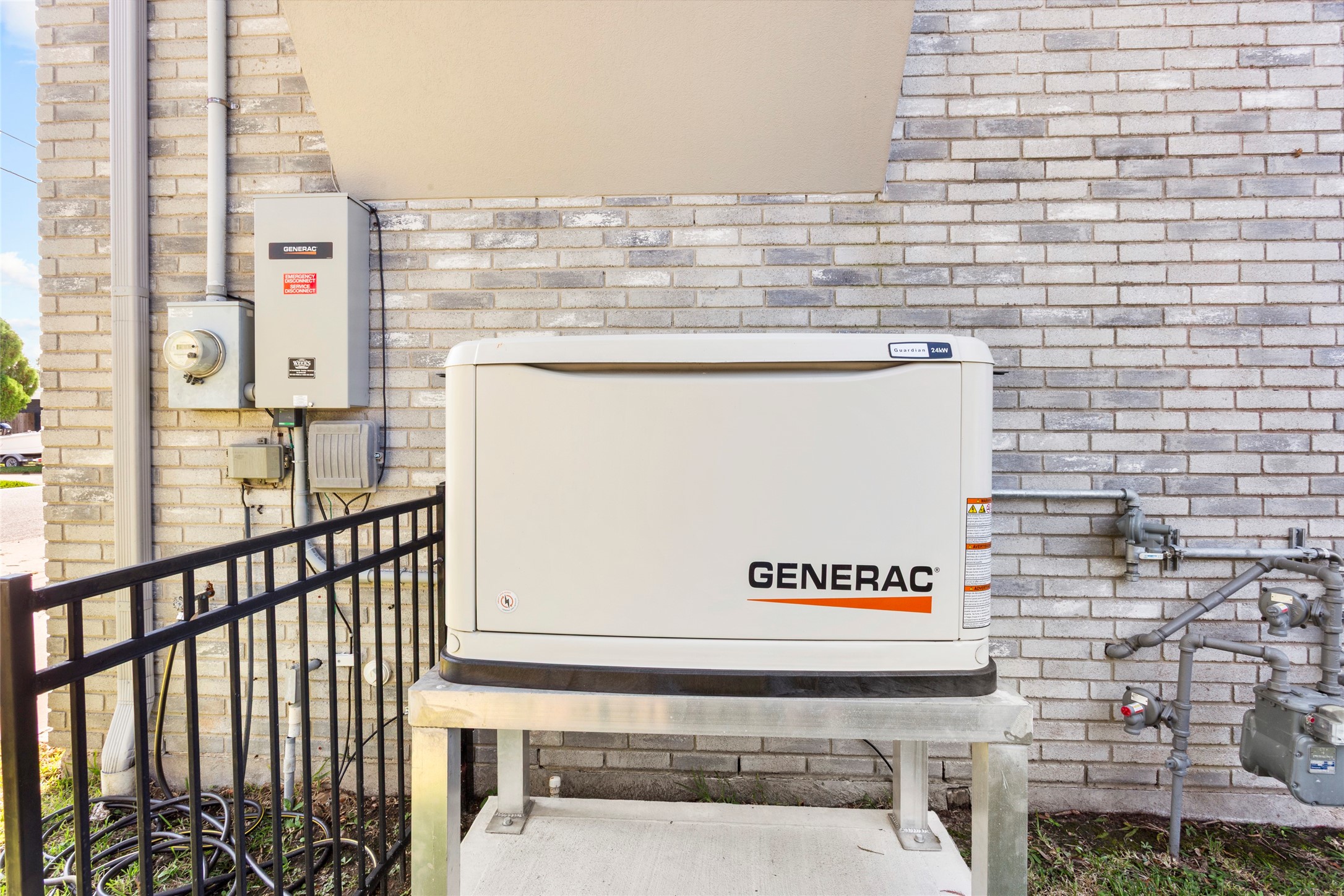 67 Harbor Lane Kemah, TX 77565 - Photo 40 of 47 Recently installed, this Generac home backup system is elevated on a metal platform with nearby utility connections, ensuring reliable power supply during outages.