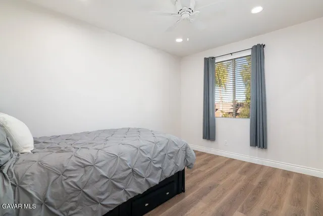 a bathroom with double vanity sink a mirror and a toilet
