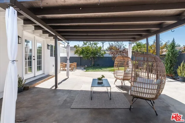 a porch with a table and chairs