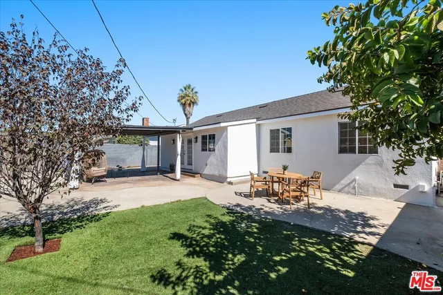 a front view of house with yard seating and green space