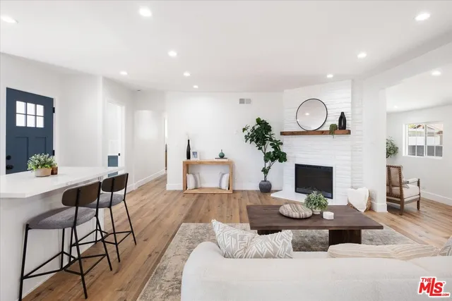 a living room with fireplace furniture and a fireplace