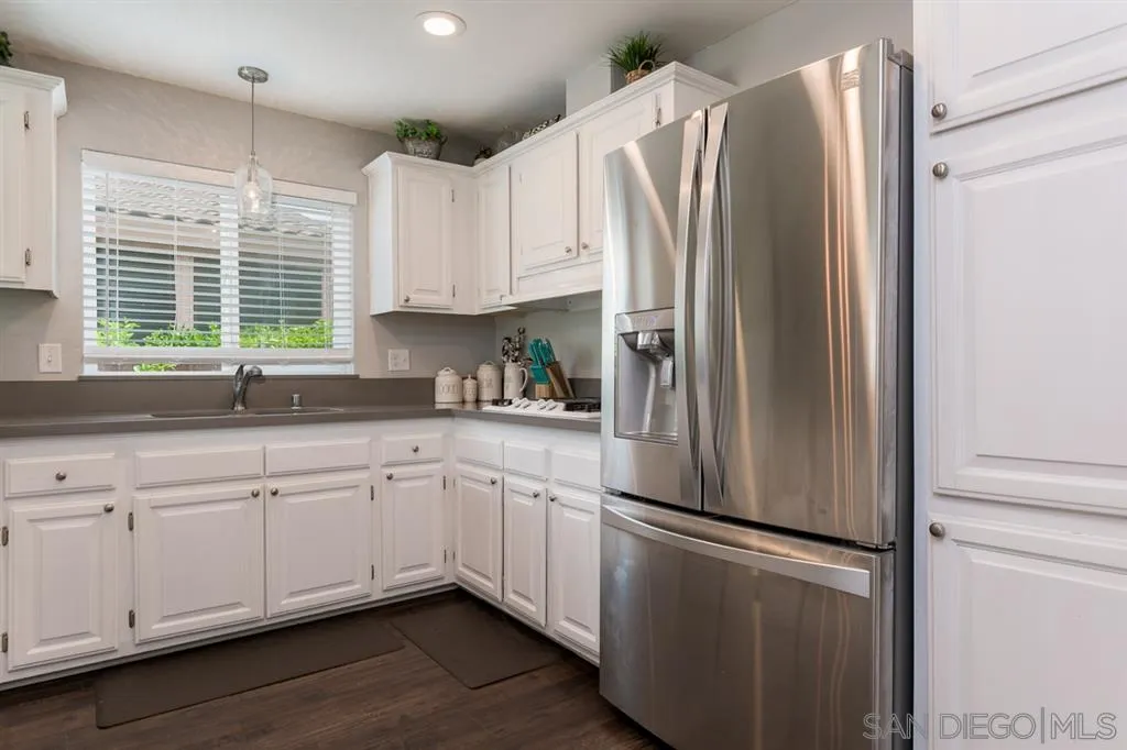 4968 Dulin Road Fallbrook, CA 92028 - Photo 13 of 25 a white refrigerator freezer sitting inside of a kitchen