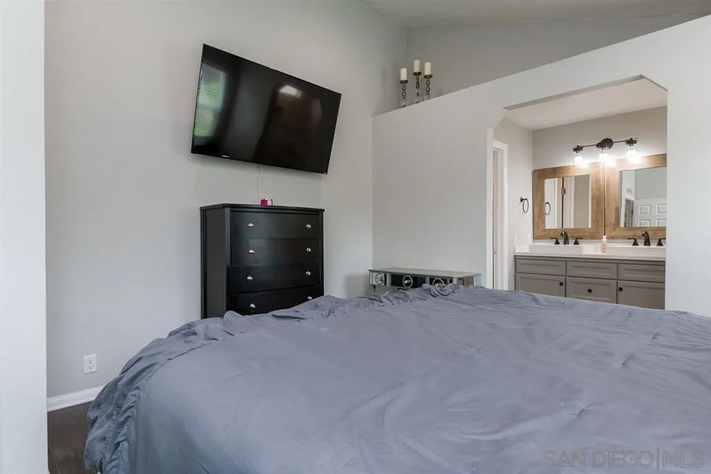 4968 Dulin Road Fallbrook, CA 92028 - Photo 17 of 25 a bedroom with a bed and a flat screen tv