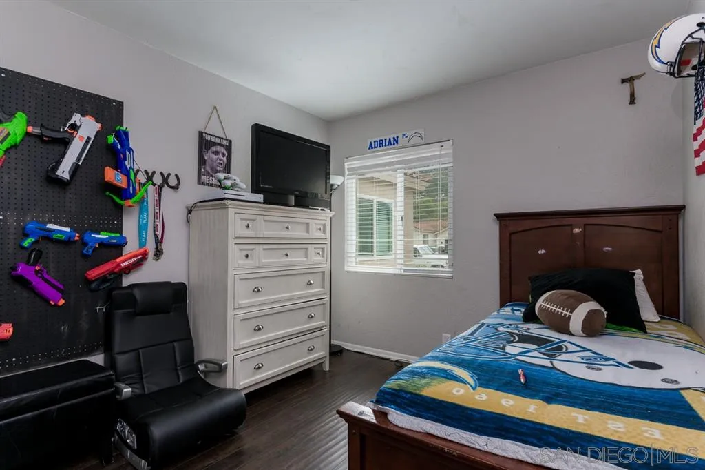 4968 Dulin Road Fallbrook, CA 92028 - Photo 18 of 25 a bedroom with a bed and a tv