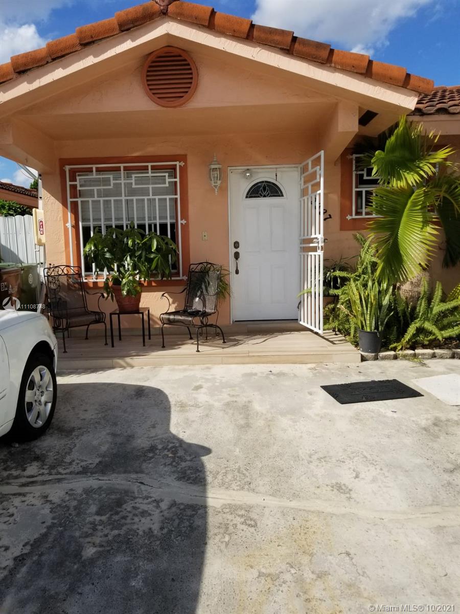 2337 West 73rd Place, Unit 7A Hialeah, FL 33016 - Photo 1 of 3 a view of a patio with a table and chairs and potted plants
