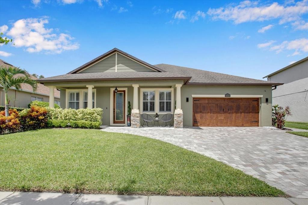 13232 Bramhall Run Orlando, FL 32832 - Photo 1 of 1 a front view of a house with a yard and potted plants