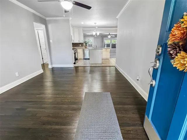 a view of a room with wooden floor and staircase
