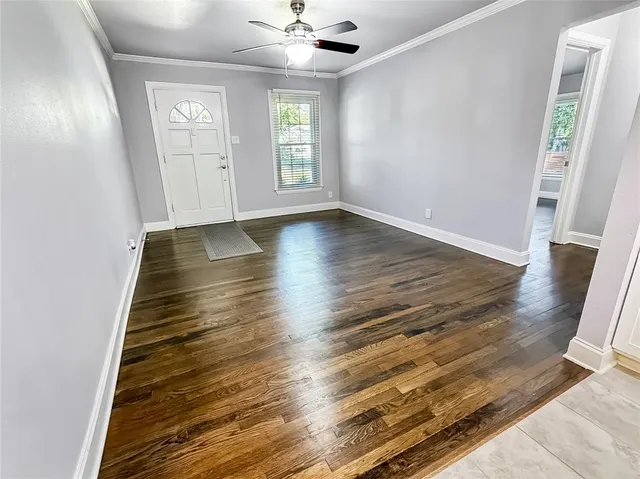 wooden floor in an empty room with a window