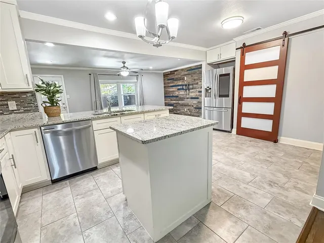 a kitchen with cabinets and window