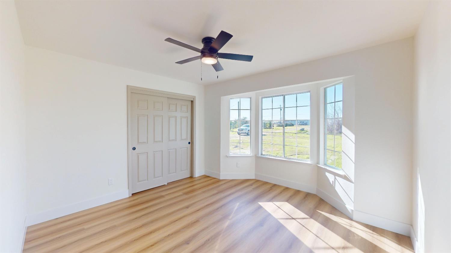 16363 Paula Road Madera, CA 93636 - Photo 18 of 30 a bedroom with a bed and a window