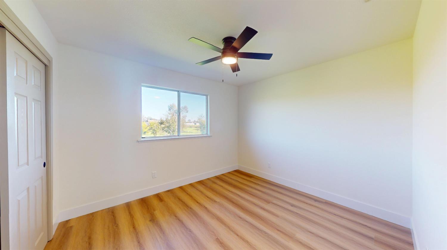 16363 Paula Road Madera, CA 93636 - Photo 19 of 30 a view of empty room with wooden floor