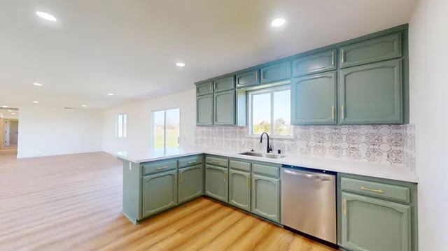 a kitchen with sink and cabinets