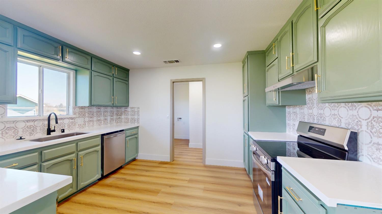 16363 Paula Road Madera, CA 93636 - Photo 6 of 30 a kitchen with a sink and wooden cabinets