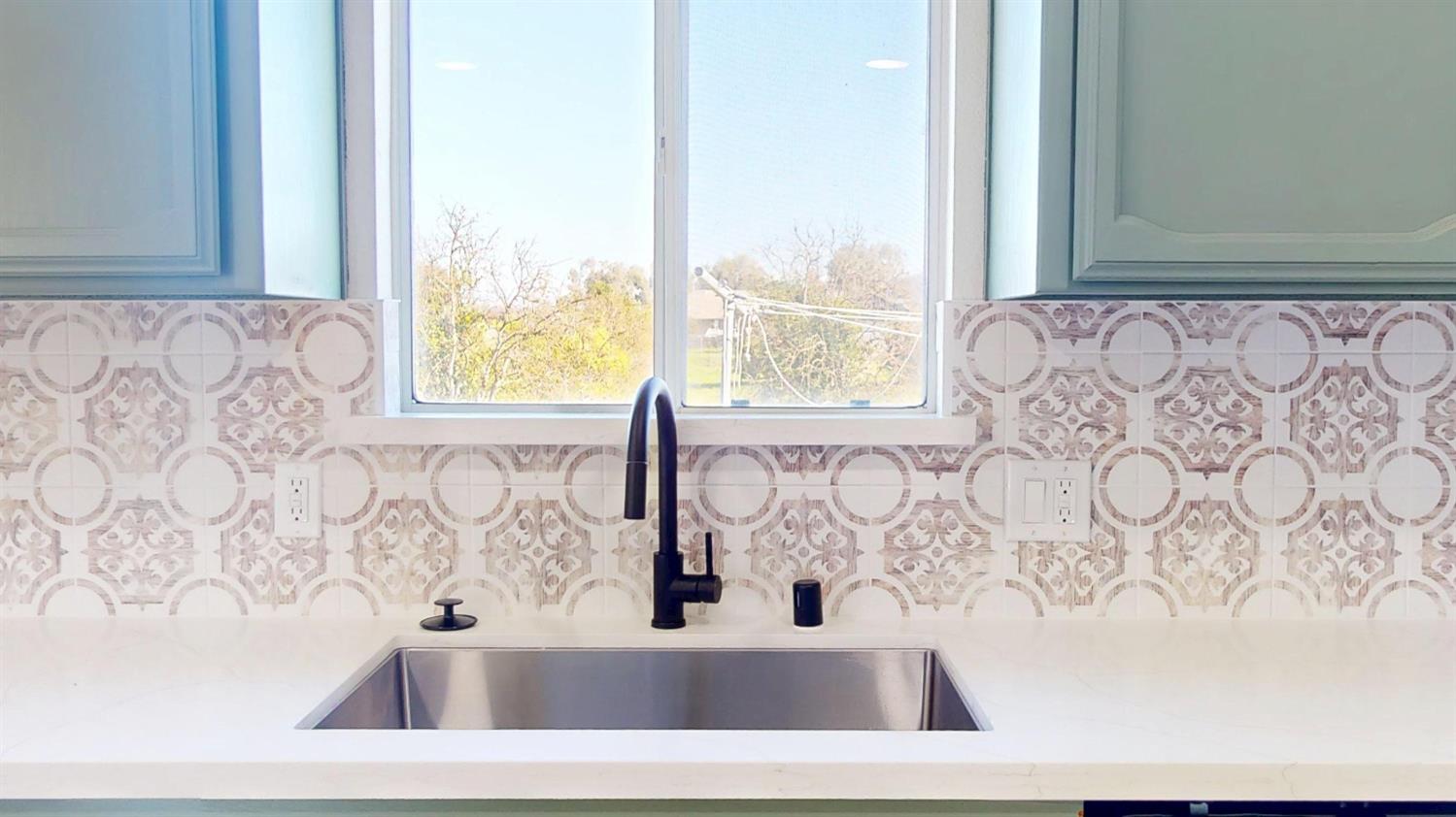 16363 Paula Road Madera, CA 93636 - Photo 8 of 30 a bathroom with a bathtub and window