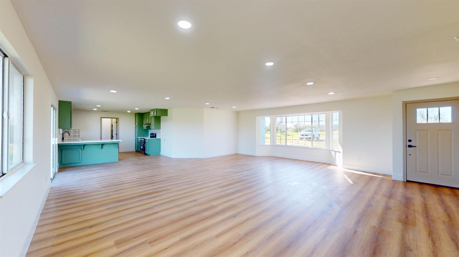 16363 Paula Road Madera, CA 93636 - Photo 9 of 30 a view of an empty room with wooden floor and a window