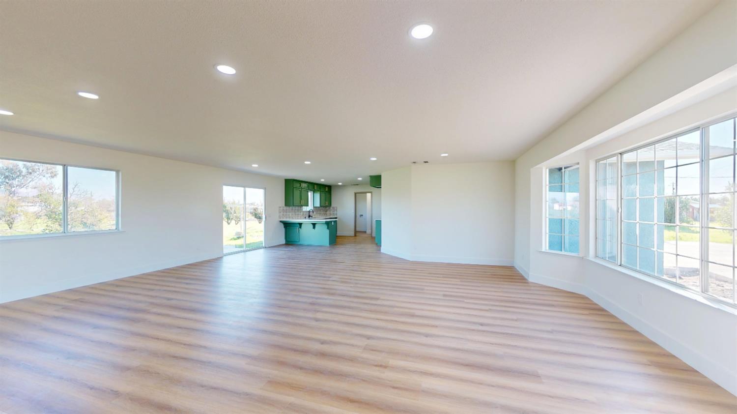 16363 Paula Road Madera, CA 93636 - Photo 10 of 30 a view of an empty room with wooden floor and a window