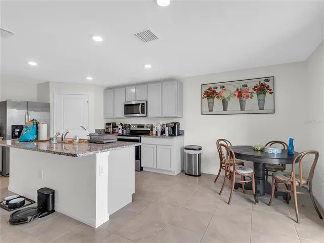 a kitchen with furniture and a refrigerator