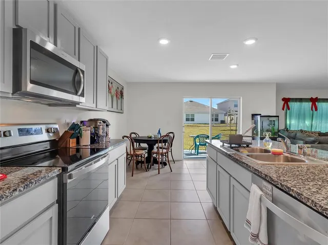 a dining room with furniture and a potted plant