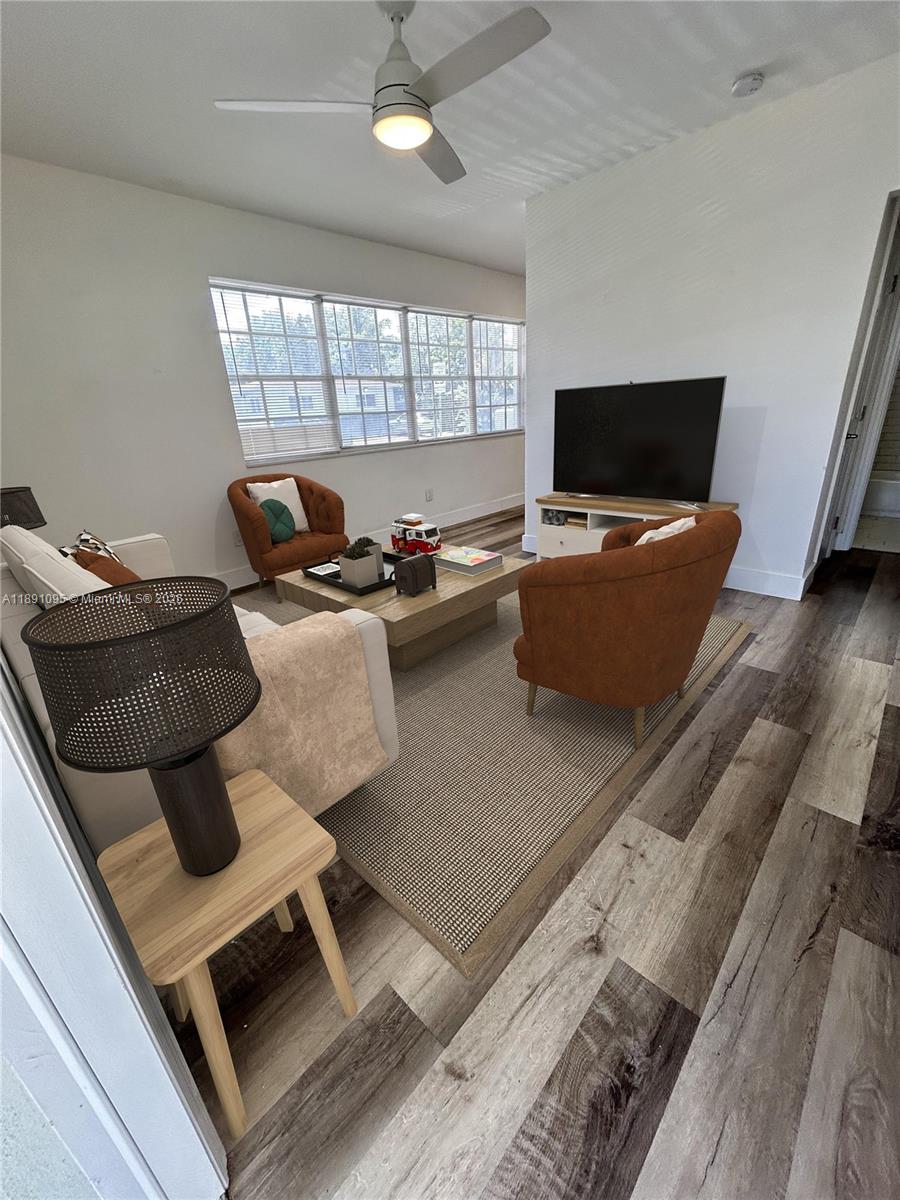 571 Northeast 67th Street, Unit 1 Miami, FL 33138 - Photo 1 of 13 a living room with furniture and a flat screen tv