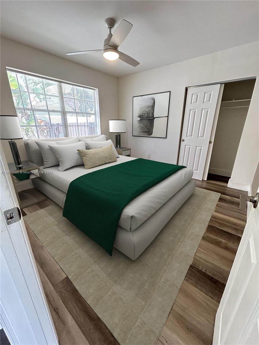 571 Northeast 67th Street, Unit 1 Miami, FL 33138 - Photo 8 of 13 a bedroom with a large bed and a window