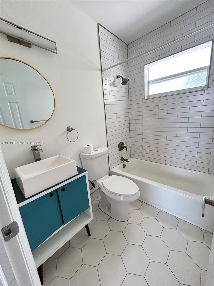 571 Northeast 67th Street, Unit 1 Miami, FL 33138 - Photo 10 of 13 a bathroom with a sink a toilet and bathtub