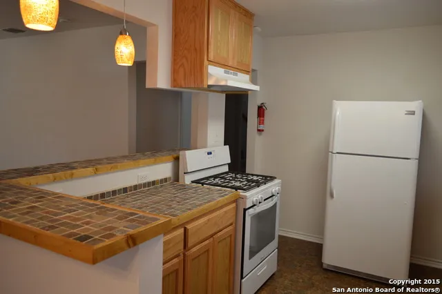 a kitchen with a stove and a refrigerator