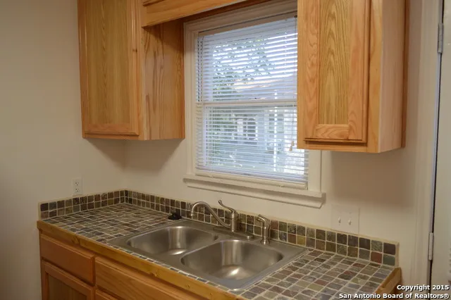 a bathroom with a sink a mirror and a window