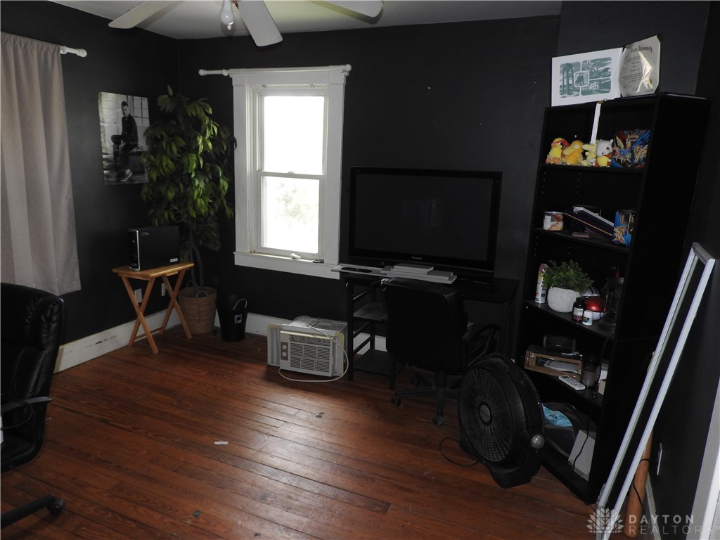2105 East Loy Road Piqua, OH 45356 - Photo 23 of 26 This versatile room features warm wood flooring, offering a cozy and functional living space.
