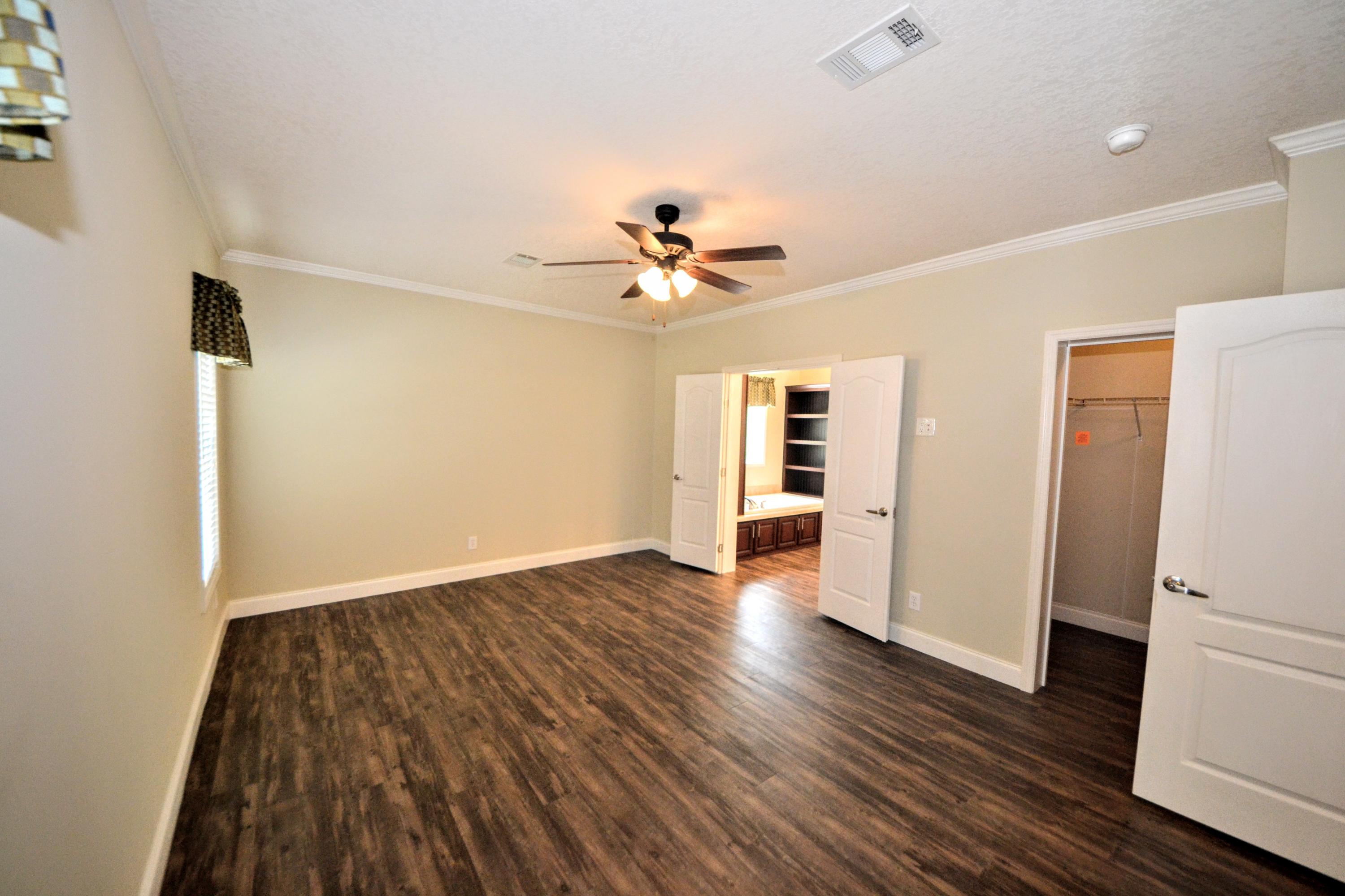 16 17th Street Santa Rosa Beach, FL 32459 - Photo 18 of 40 an empty room with wooden floor and a ceiling fan