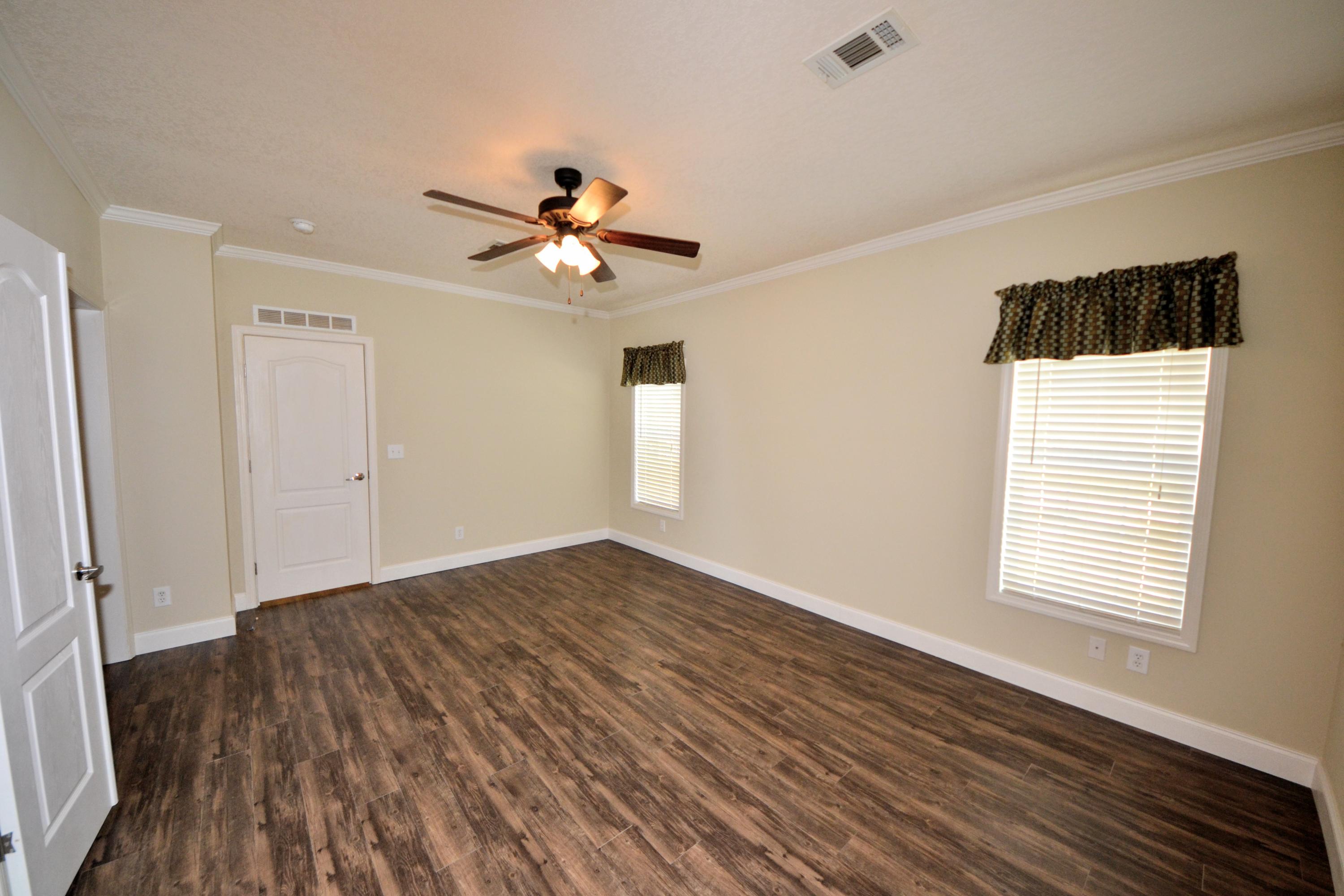 16 17th Street Santa Rosa Beach, FL 32459 - Photo 25 of 40 a view of empty room with wooden floor and fan
