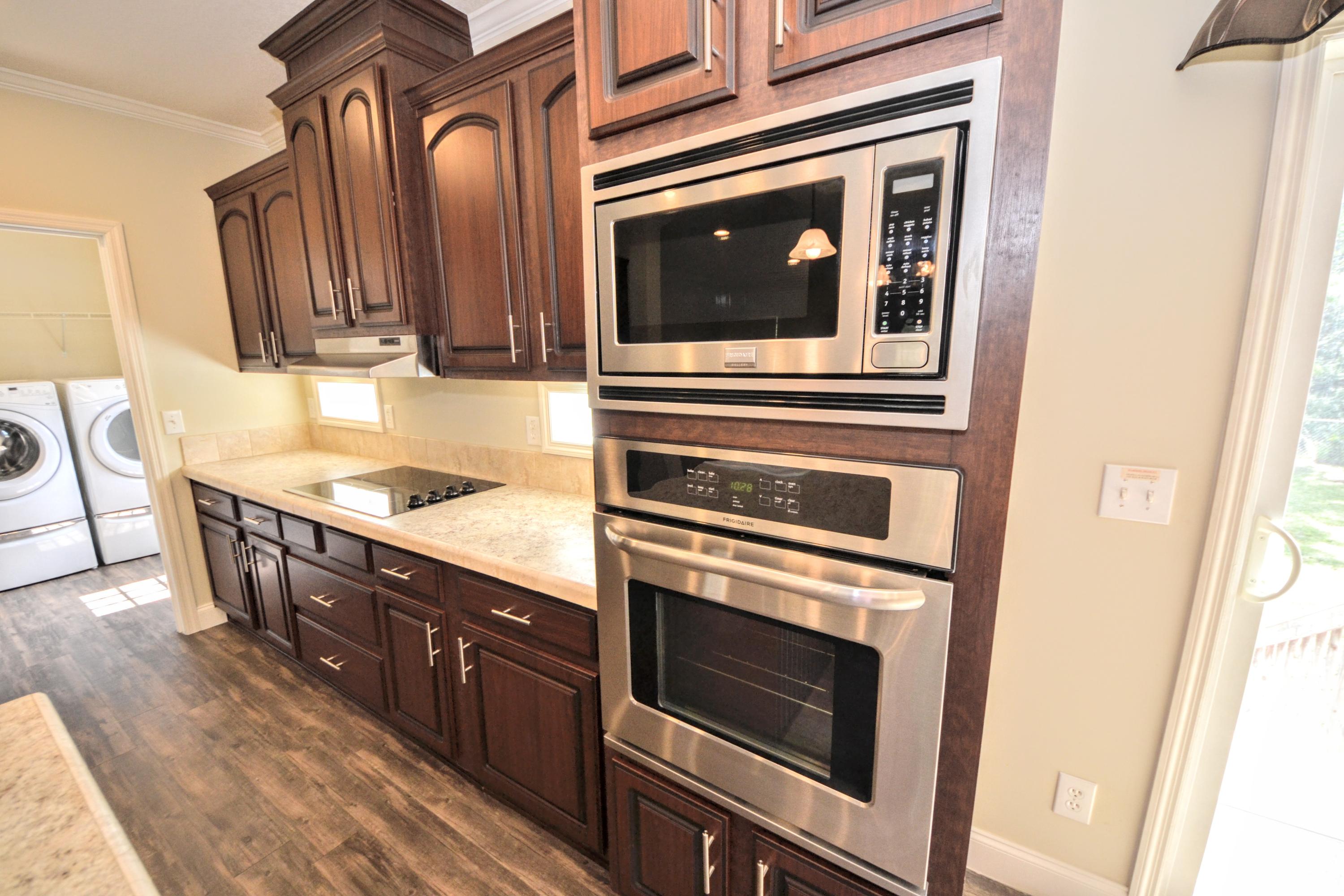 16 17th Street Santa Rosa Beach, FL 32459 - Photo 28 of 40 a kitchen with stainless steel appliances granite countertop a stove microwave and cabinets