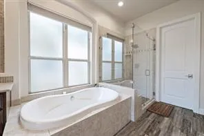 a bathroom with a tub and a sink