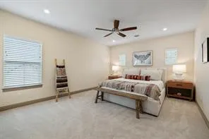 a white bed sitting in a bedroom next to a window