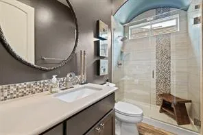 a bathroom with a sink a toilet and shower