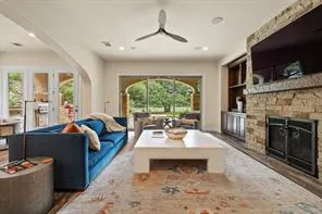 a living room with furniture a flat screen tv and a fireplace