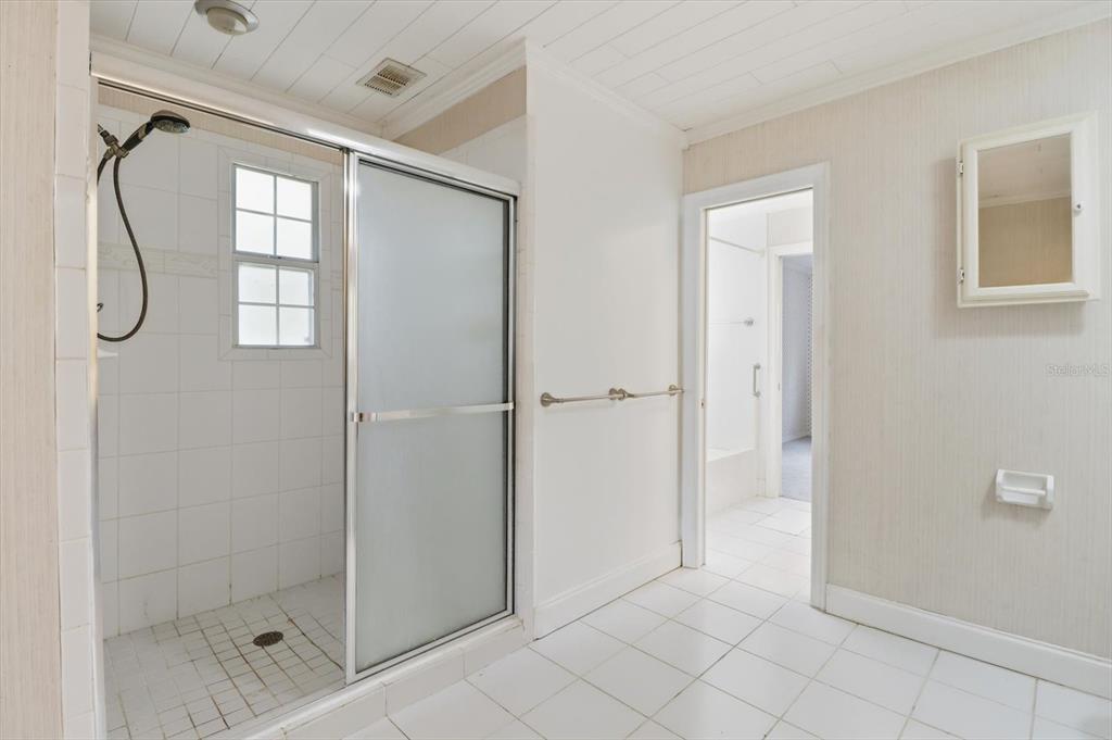 11 Patricia Road Yankeetown, FL 34498 - Photo 11 of 30 a bathroom with a glass shower door