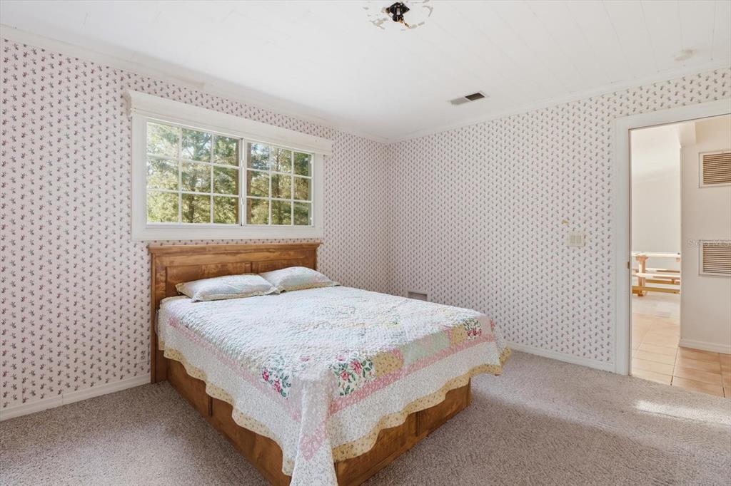 11 Patricia Road Yankeetown, FL 34498 - Photo 13 of 30 a bedroom with a bed and window