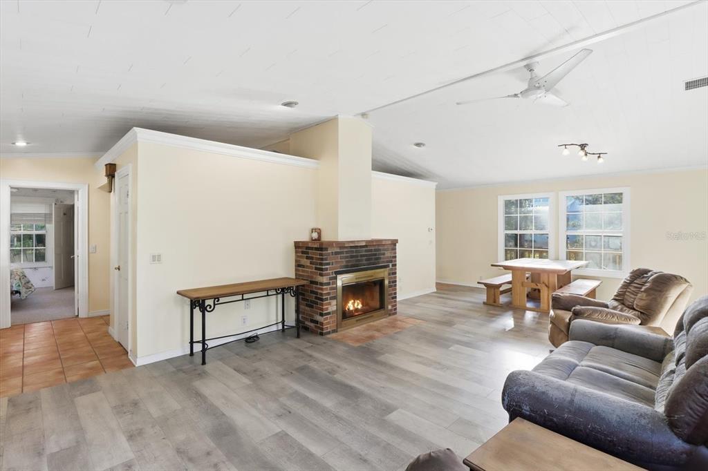 11 Patricia Road Yankeetown, FL 34498 - Photo 6 of 30 a living room with furniture a fireplace and a flat screen tv