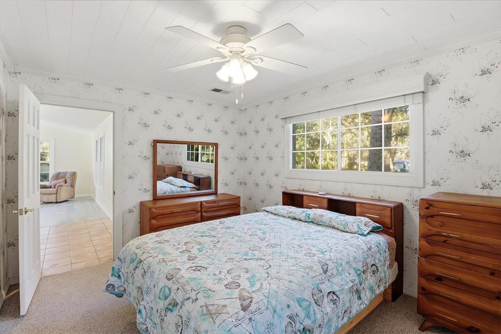 11 Patricia Road Yankeetown, FL 34498 - Photo 9 of 30 a bedroom with a large bed and a chandelier