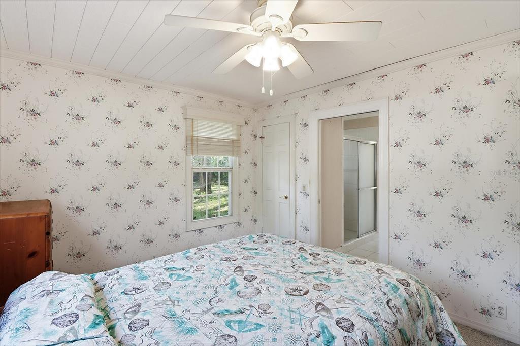 11 Patricia Road Yankeetown, FL 34498 - Photo 10 of 30 a bedroom with a bed and a chandelier