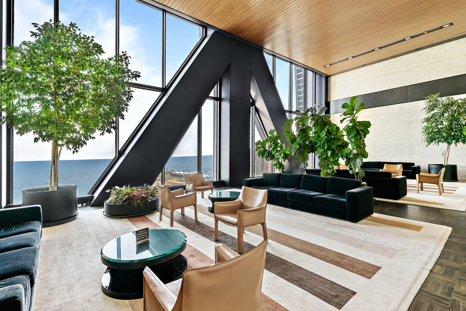 175 East Delaware Place, Unit 5412 Chicago, IL 60611 - Photo 3 of 20 a living room with furniture potted plant and a large window