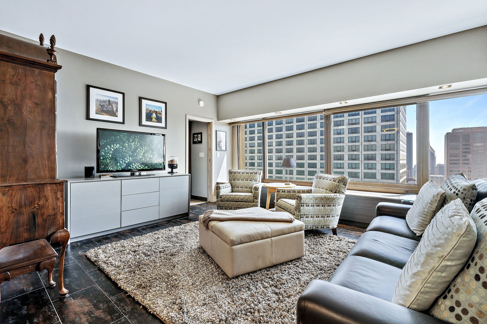 175 East Delaware Place, Unit 5412 Chicago, IL 60611 - Photo 5 of 20 a living room with furniture and a flat screen tv