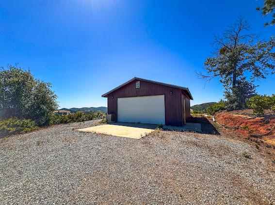 9080 El Dorado Trail Mountain Ranch, CA 95246 - Photo 48 of 48 a house view with a space and trees in the background