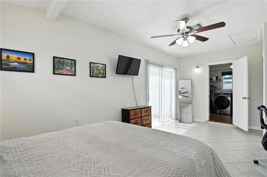 1423 Charles Road Fort Myers, FL 33919 - Photo 13 of 26 Tiled bedroom featuring washer / clothes dryer, multiple windows, beamed ceiling, attic access, and a ceiling fan