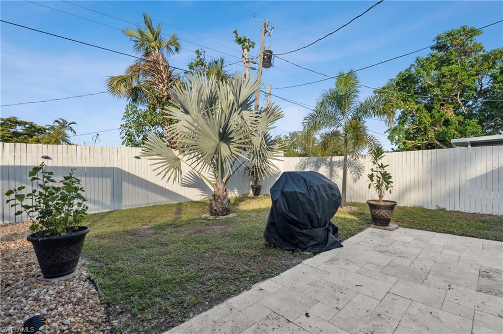 1423 Charles Road Fort Myers, FL 33919 - Photo 22 of 26 Fenced backyard with a patio area