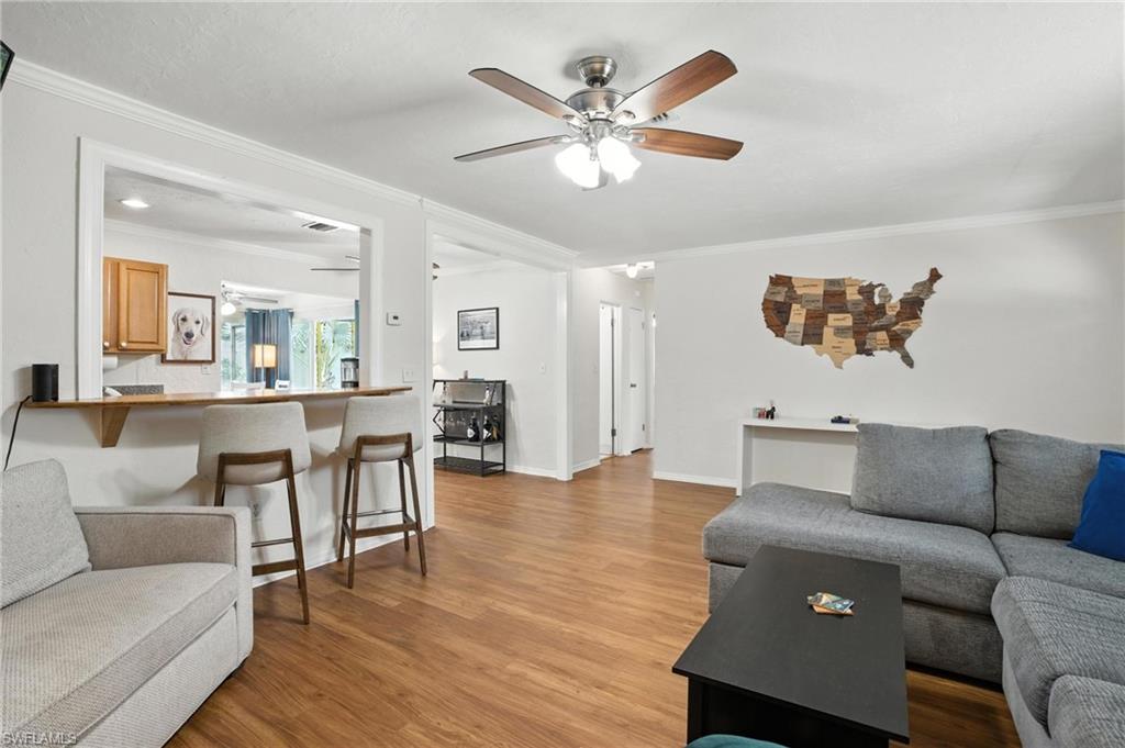 1423 Charles Road Fort Myers, FL 33919 - Photo 8 of 26 Living room with ornamental molding, a ceiling fan, and light wood-style floors