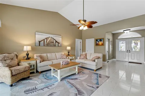 a kitchen with granite countertop a refrigerator stove microwave and sink
