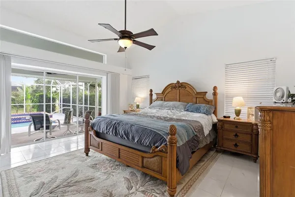 a bedroom with a bed and a television